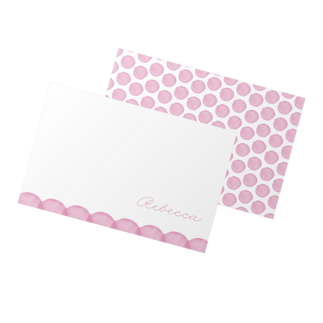 Folded card with pink polka dot design on a white background