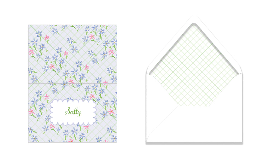 Floral-patterned card with a grid-lined envelope on a white background