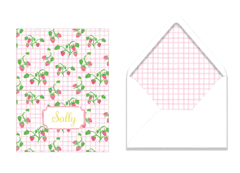 Greeting card with strawberry pattern and matching envelope on a white background